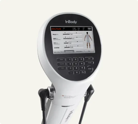 Close-up of an InBody body composition analyzer displaying weight, muscle mass, and fat analysis on its screen, used for precise health and fitness measurements.
