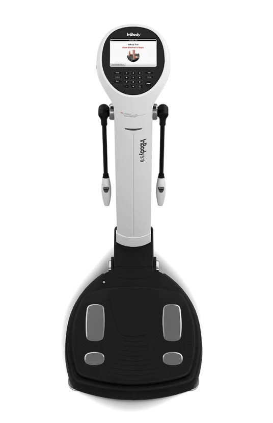 Full view of the InBody 570 body composition analyzer with hand grips and foot sensors, designed for precise body fat, muscle mass, and hydration level measurements.